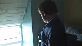 Gavin looks out from our cosy attic bedroom at Clear Island Youth Hostel to South Harbour 